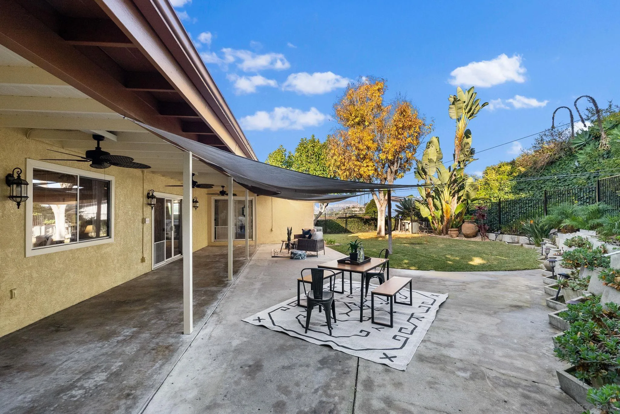 5111 Dorman Drive San Diego, CA 92115 - Photo 39 of 59 a view of a patio with table and chairs and potted plants