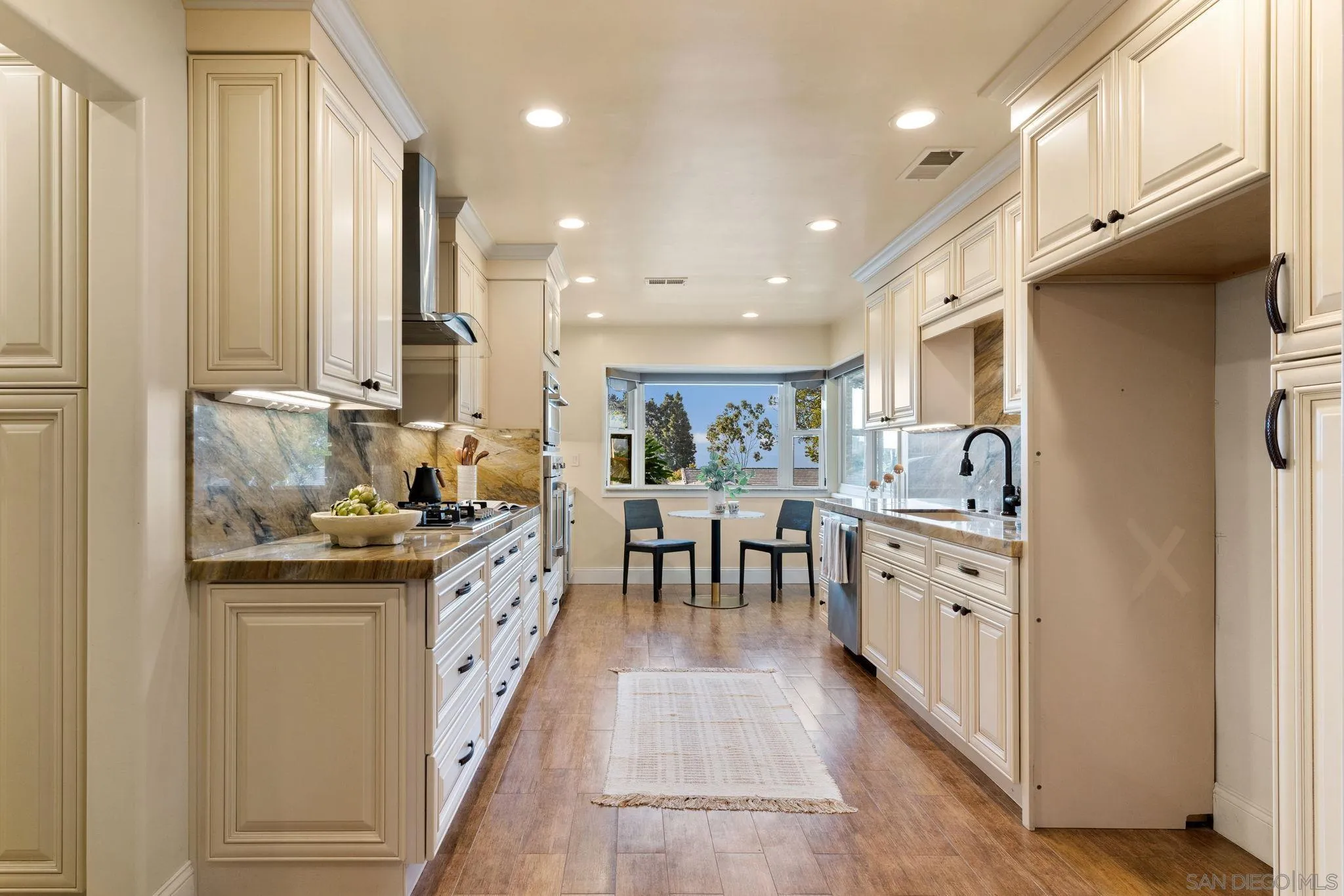 5111 Dorman Drive San Diego, CA 92115 - Photo 6 of 59 a kitchen with granite countertop a sink appliances cabinets and furniture