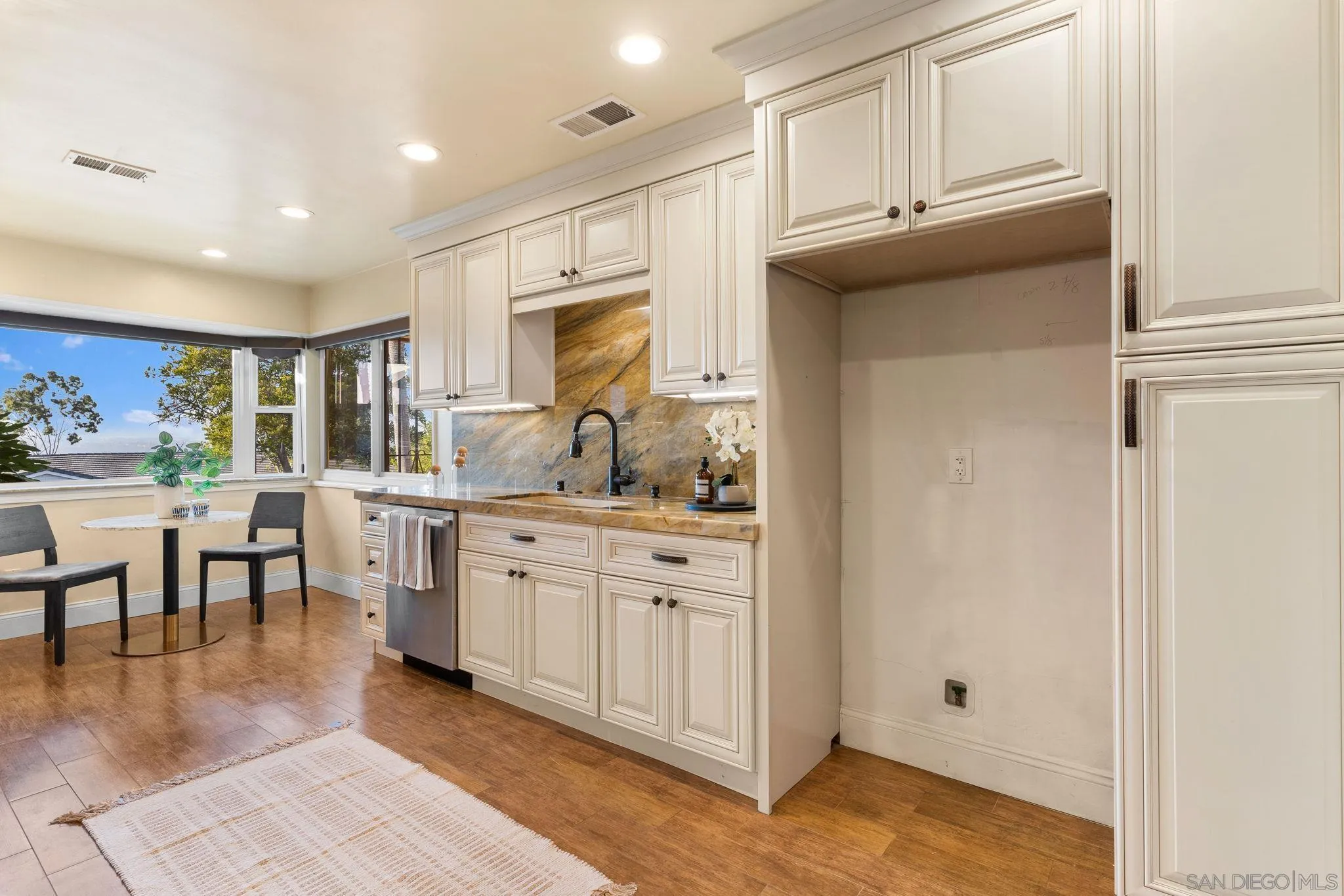 5111 Dorman Drive San Diego, CA 92115 - Photo 8 of 59 a kitchen with granite countertop a stove a sink and a refrigerator
