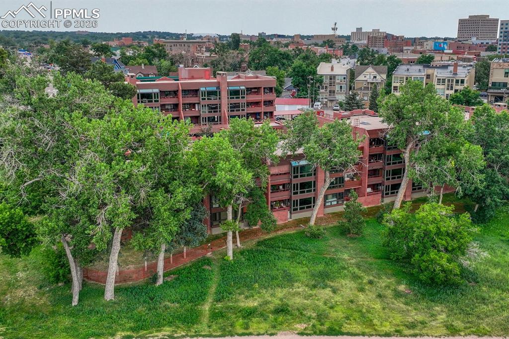 a backyard with table and chairs and potted plants