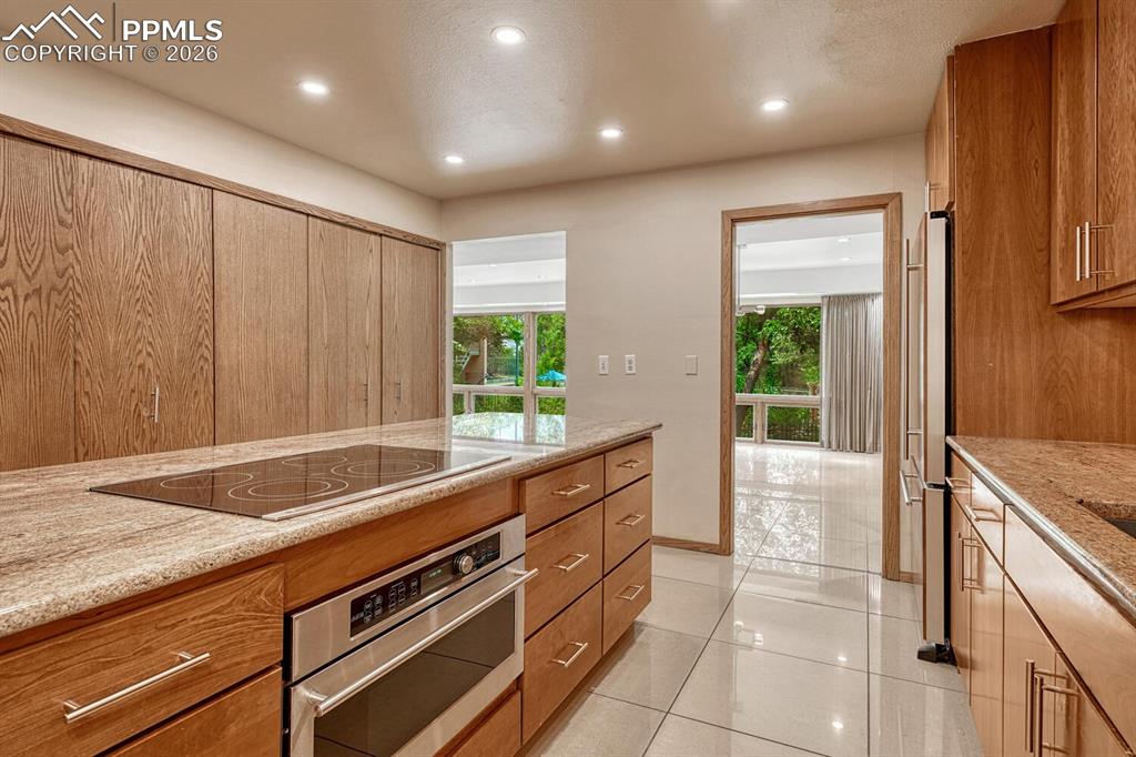 75 East Boulder Street Colorado Springs, CO 80903 - Photo 11 of 50 a large kitchen with kitchen island granite countertop a sink and a stove