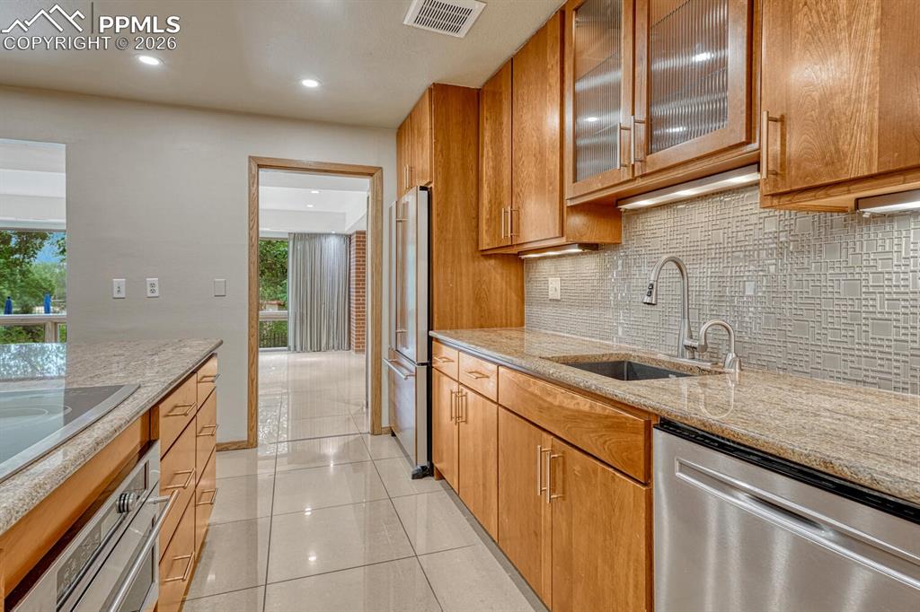 75 East Boulder Street Colorado Springs, CO 80903 - Photo 13 of 50 a kitchen with stainless steel appliances a sink stove and cabinets