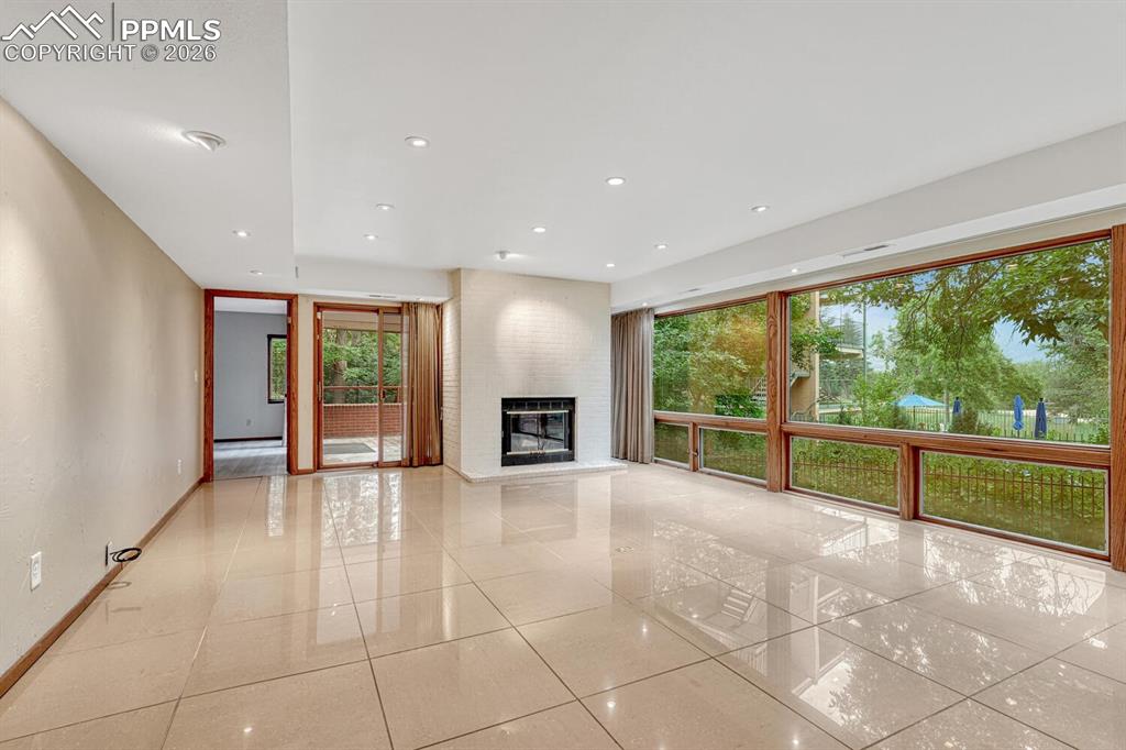 75 East Boulder Street Colorado Springs, CO 80903 - Photo 19 of 50 a view of an empty room with a fireplace and a large window