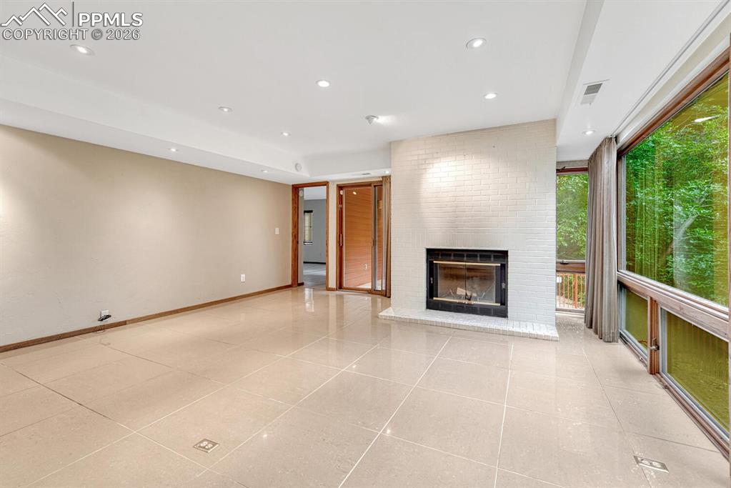 75 East Boulder Street Colorado Springs, CO 80903 - Photo 20 of 50 a view of an empty room with a fireplace and a window
