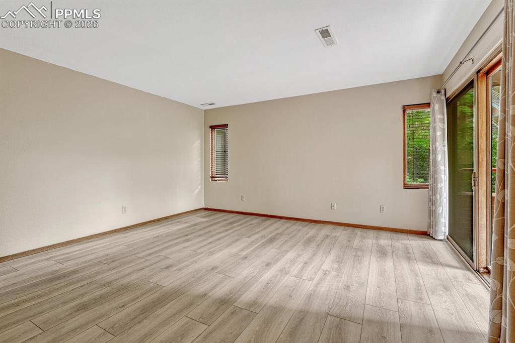 75 East Boulder Street Colorado Springs, CO 80903 - Photo 21 of 50 a view of an empty room with wooden floor and a window