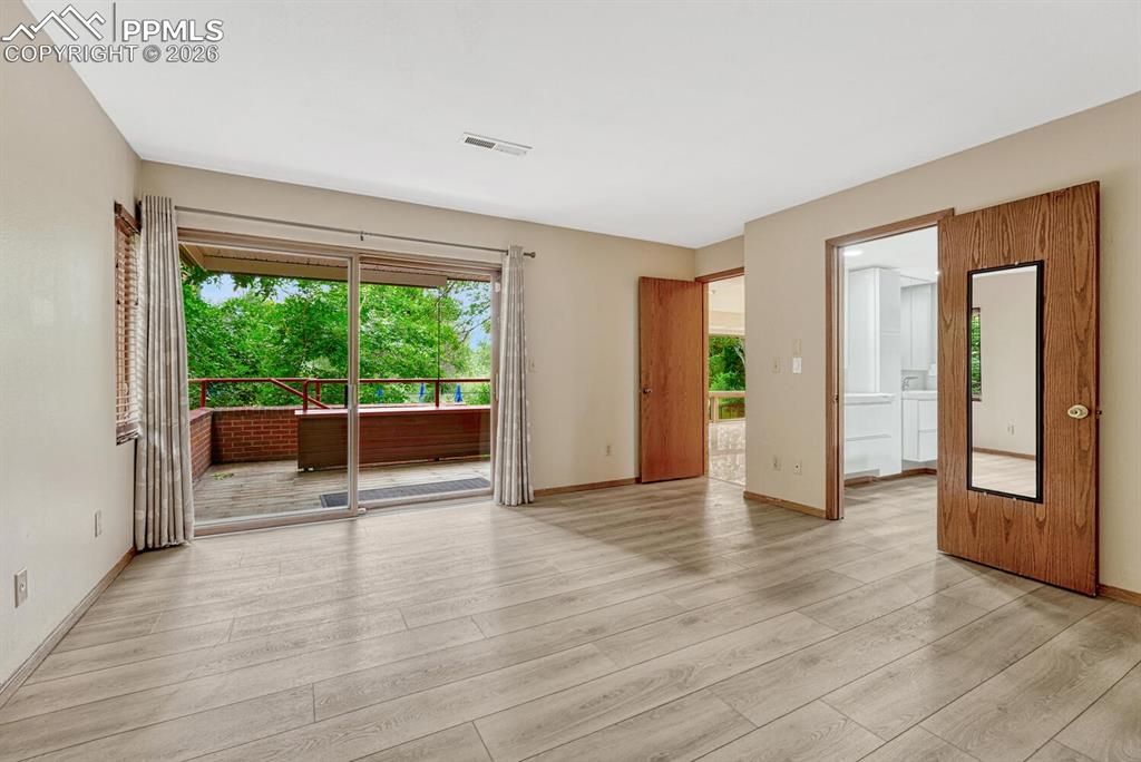 75 East Boulder Street Colorado Springs, CO 80903 - Photo 23 of 50 a view of an empty room with wooden floor and a window