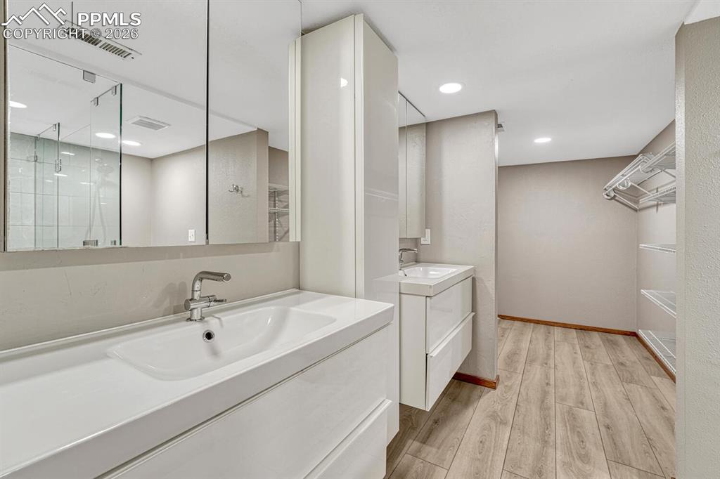 75 East Boulder Street Colorado Springs, CO 80903 - Photo 25 of 50 a bathroom with a double vanity sink a mirror and a bathtub