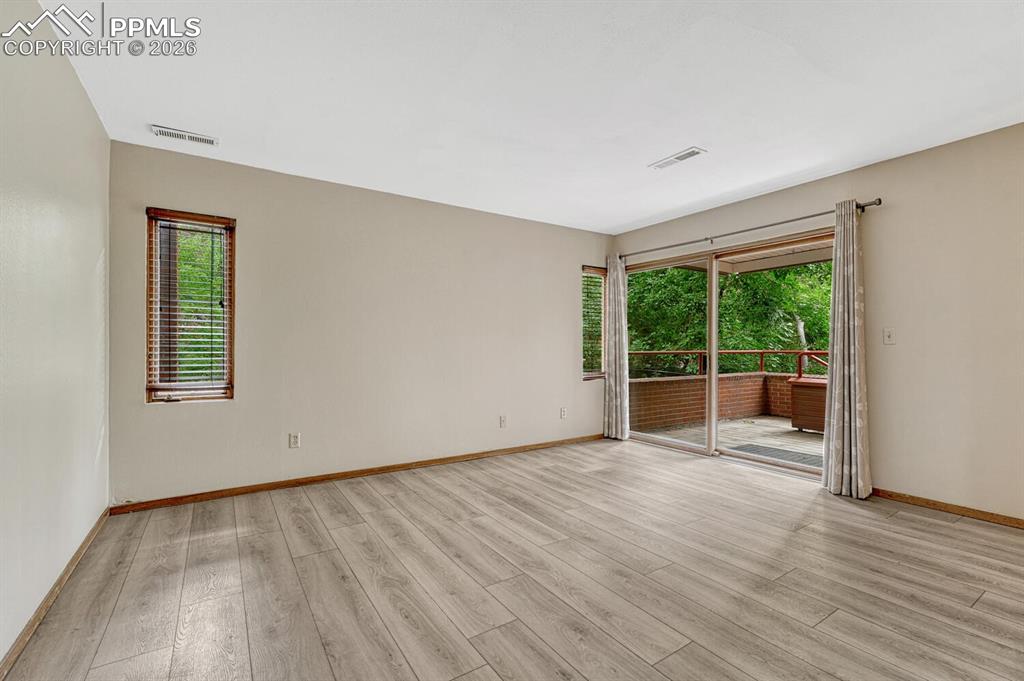75 East Boulder Street Colorado Springs, CO 80903 - Photo 25 of 50 a view of an empty room with wooden floor and a window