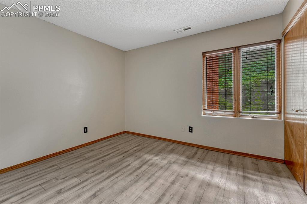 75 East Boulder Street Colorado Springs, CO 80903 - Photo 29 of 50 a view of empty room with wooden floor and fan