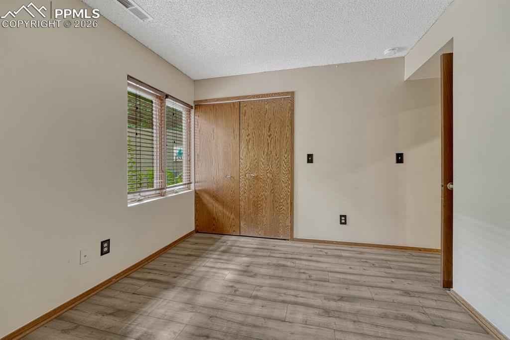 75 East Boulder Street Colorado Springs, CO 80903 - Photo 31 of 50 a view of an empty room with wooden floor and a window