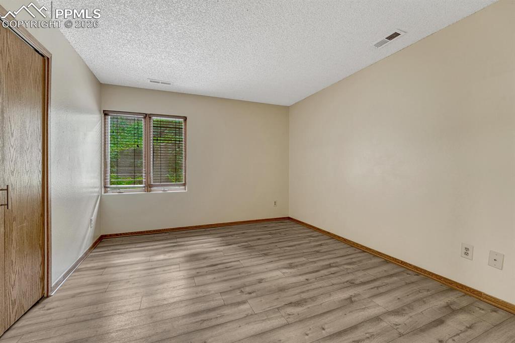 75 East Boulder Street Colorado Springs, CO 80903 - Photo 33 of 50 a view of an empty room with wooden floor and a window