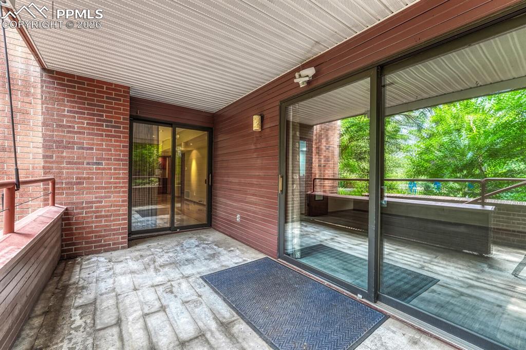 75 East Boulder Street Colorado Springs, CO 80903 - Photo 38 of 50 a view of a porch with wooden floor and iron stairs