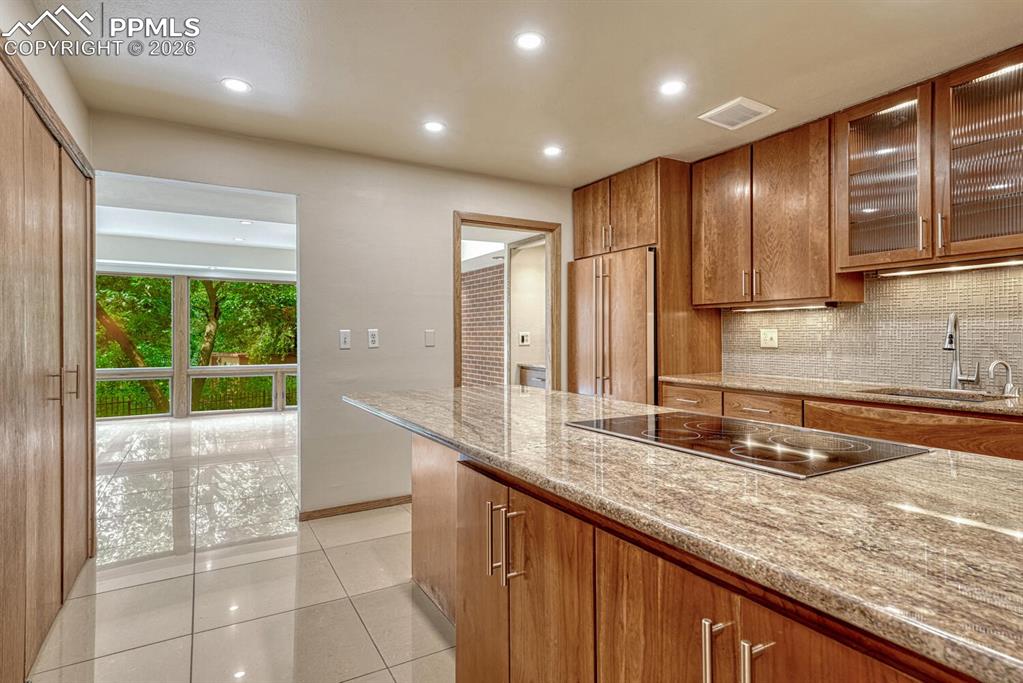 75 East Boulder Street Colorado Springs, CO 80903 - Photo 8 of 50 a large kitchen with granite countertop a sink and a large window