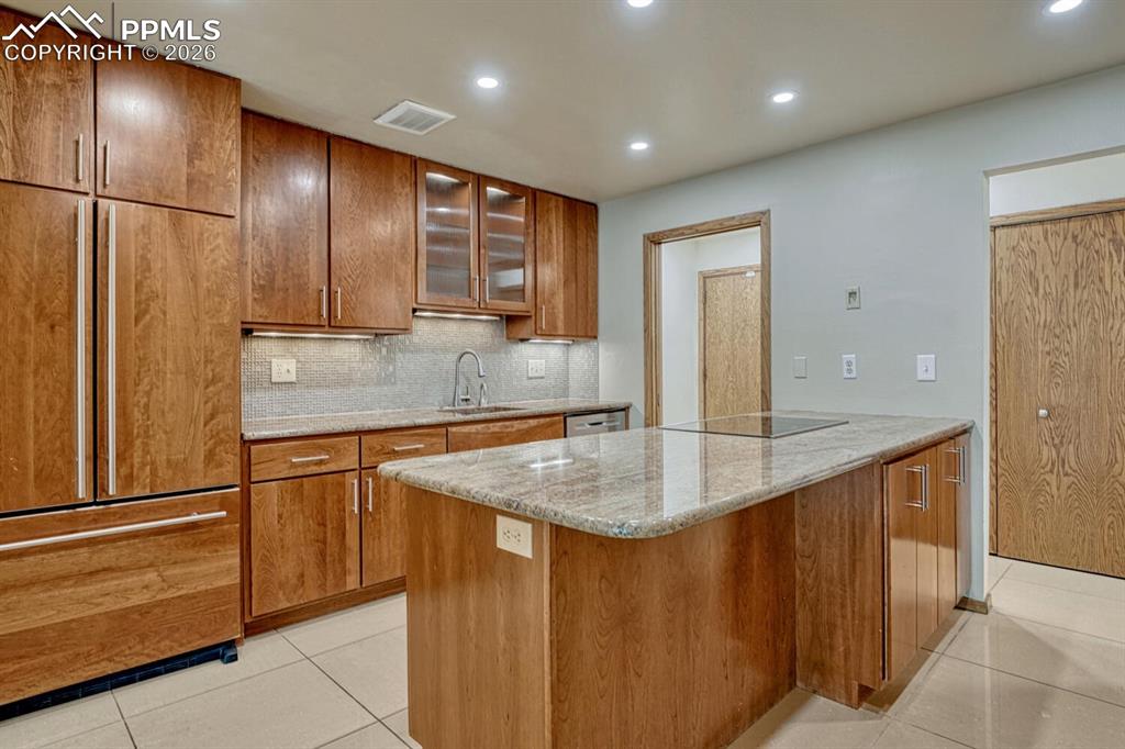 75 East Boulder Street Colorado Springs, CO 80903 - Photo 9 of 50 a kitchen with kitchen island granite countertop a sink and cabinets