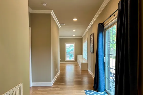 a view of a hallway with wooden floor