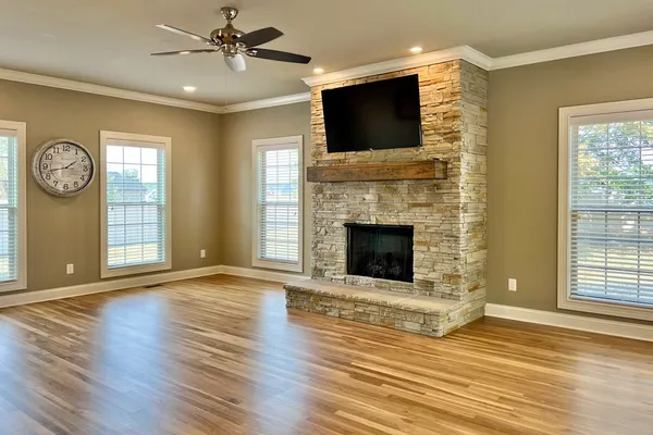 a view of a livingroom with a fireplace a fireplace and wooden floor