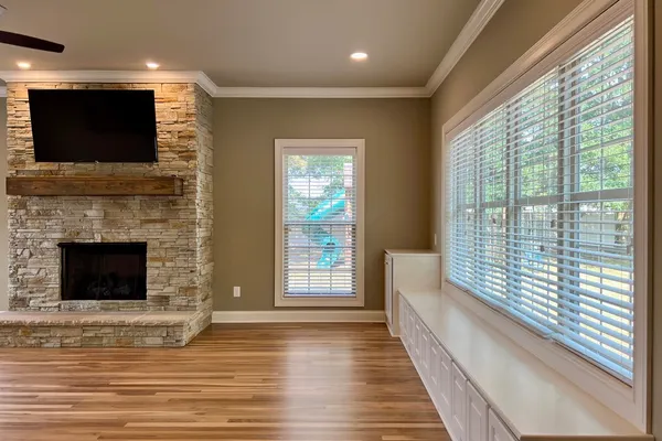 a view of a livingroom with a fireplace and window