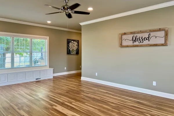 wooden floor in an empty room with a window