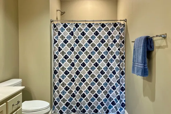 a bathroom with a black and white shower curtain