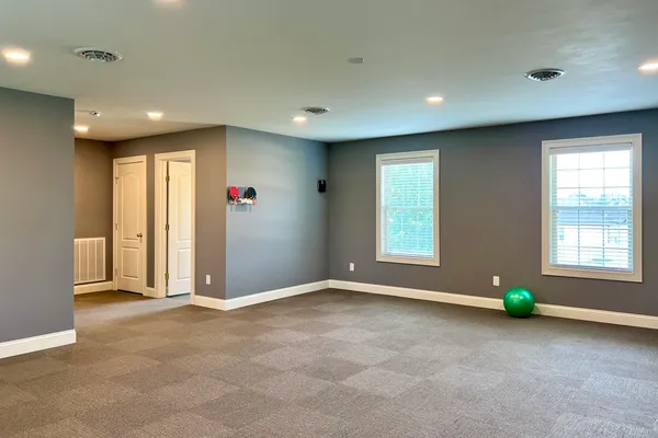 a view of a livingroom with furniture and staircase