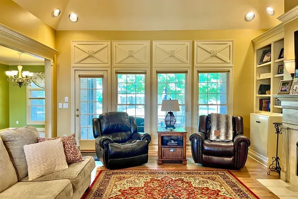 a living room with furniture and a floor to ceiling window