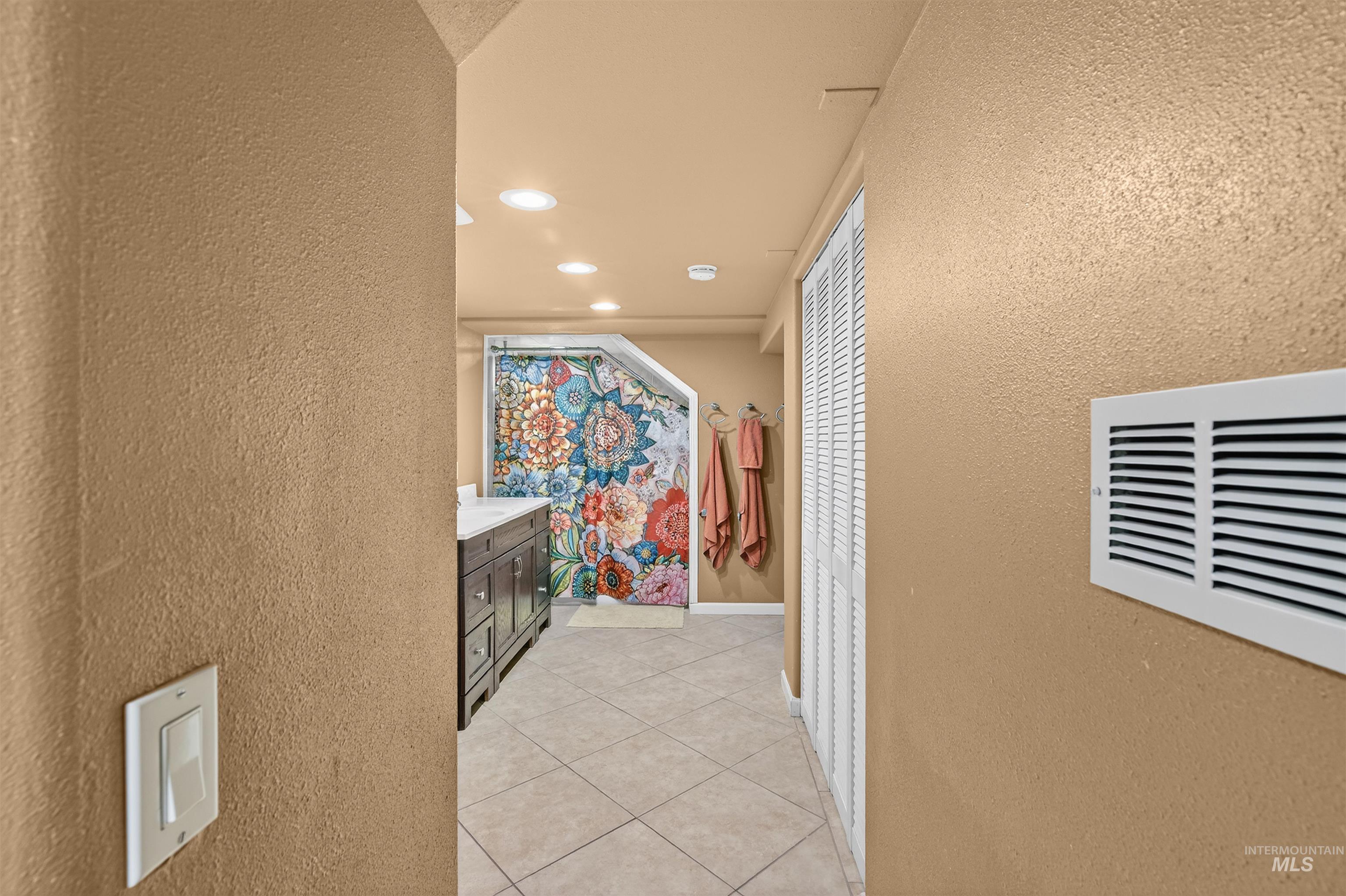 835 12th Street Clarkston, WA 99403 - Photo 23 of 39 Corridor featuring a textured wall, recessed lighting, and light tile patterned floors