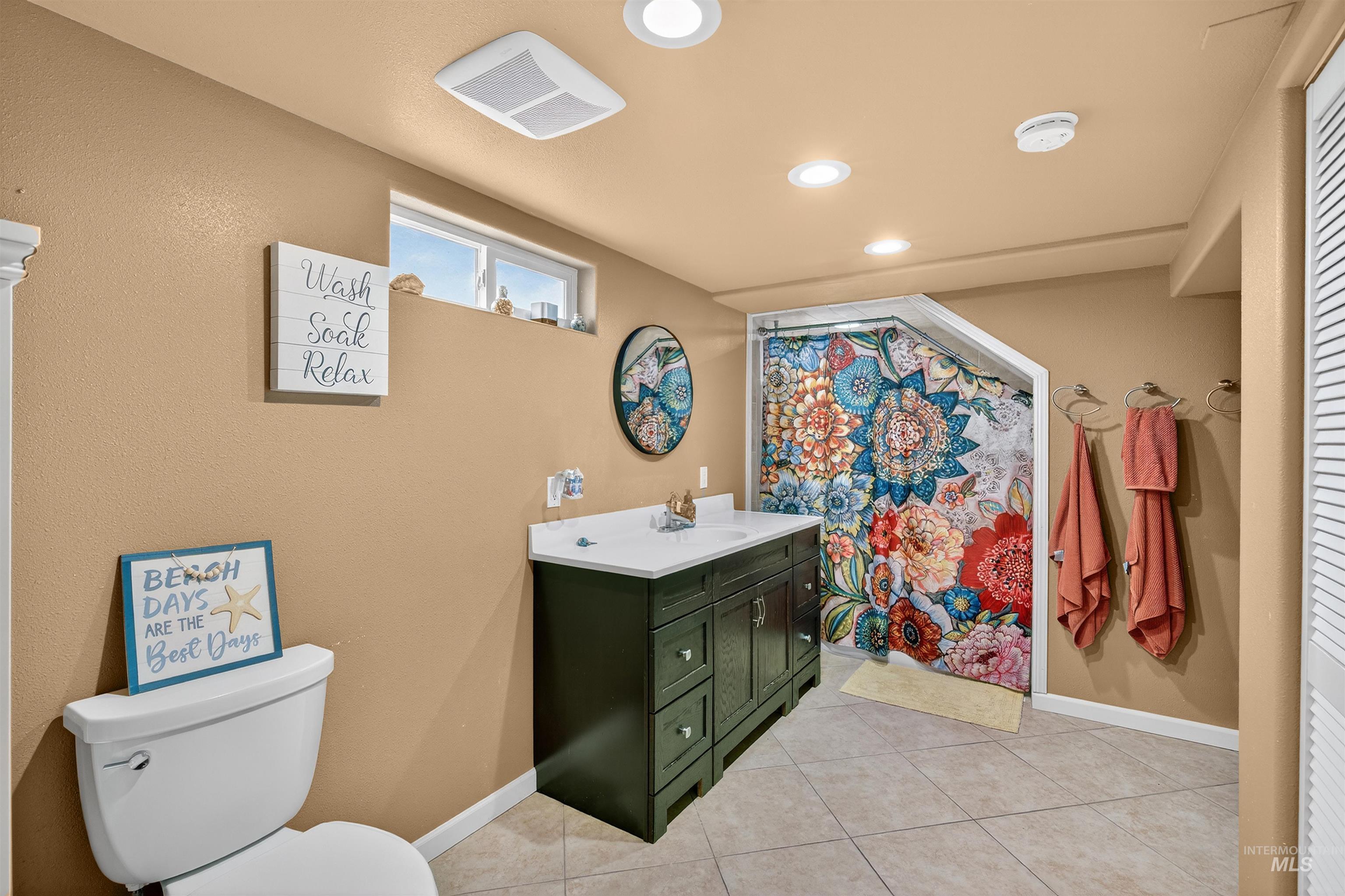 835 12th Street Clarkston, WA 99403 - Photo 24 of 39 Bathroom featuring vanity, a shower with curtain, light tile patterned floors, and recessed lighting