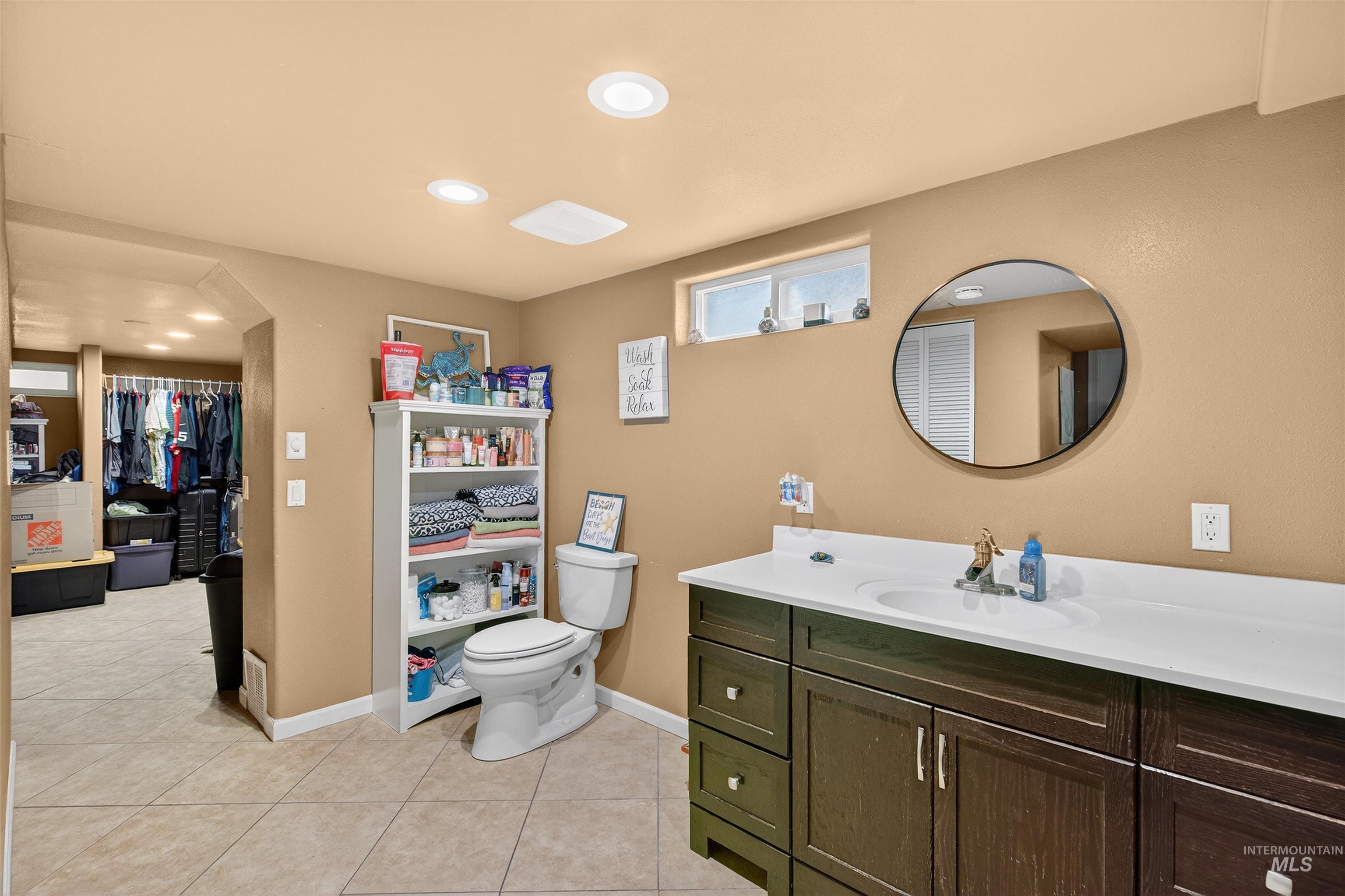 835 12th Street Clarkston, WA 99403 - Photo 25 of 39 Bathroom with vanity, a walk in closet, light tile patterned floors, and recessed lighting