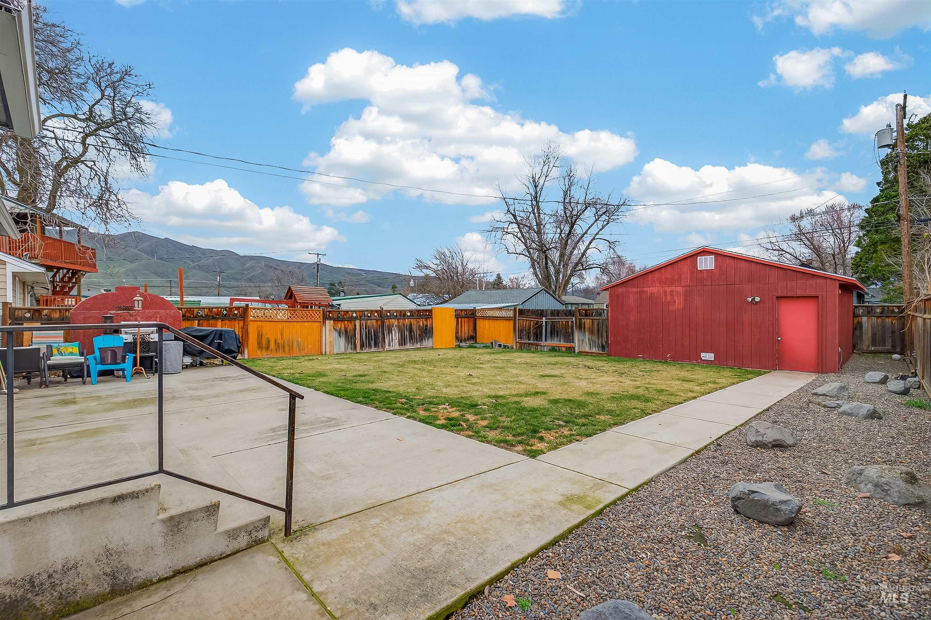 835 12th Street Clarkston, WA 99403 - Photo 28 of 39 Fenced backyard featuring a mountain view, a patio area, and an outdoor structure