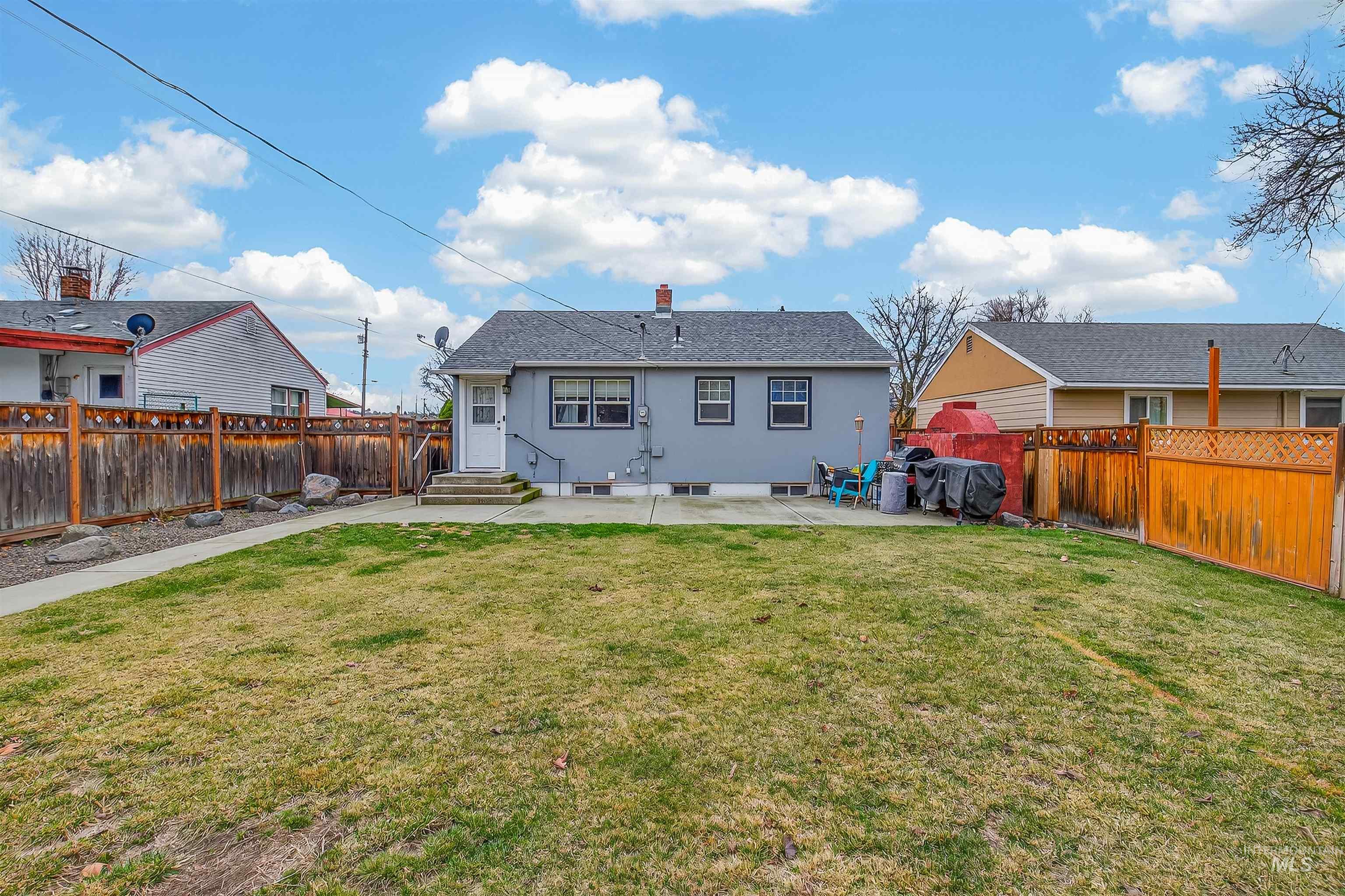 835 12th Street Clarkston, WA 99403 - Photo 31 of 39 Back of property featuring a patio area, a chimney, a fenced backyard, and entry steps