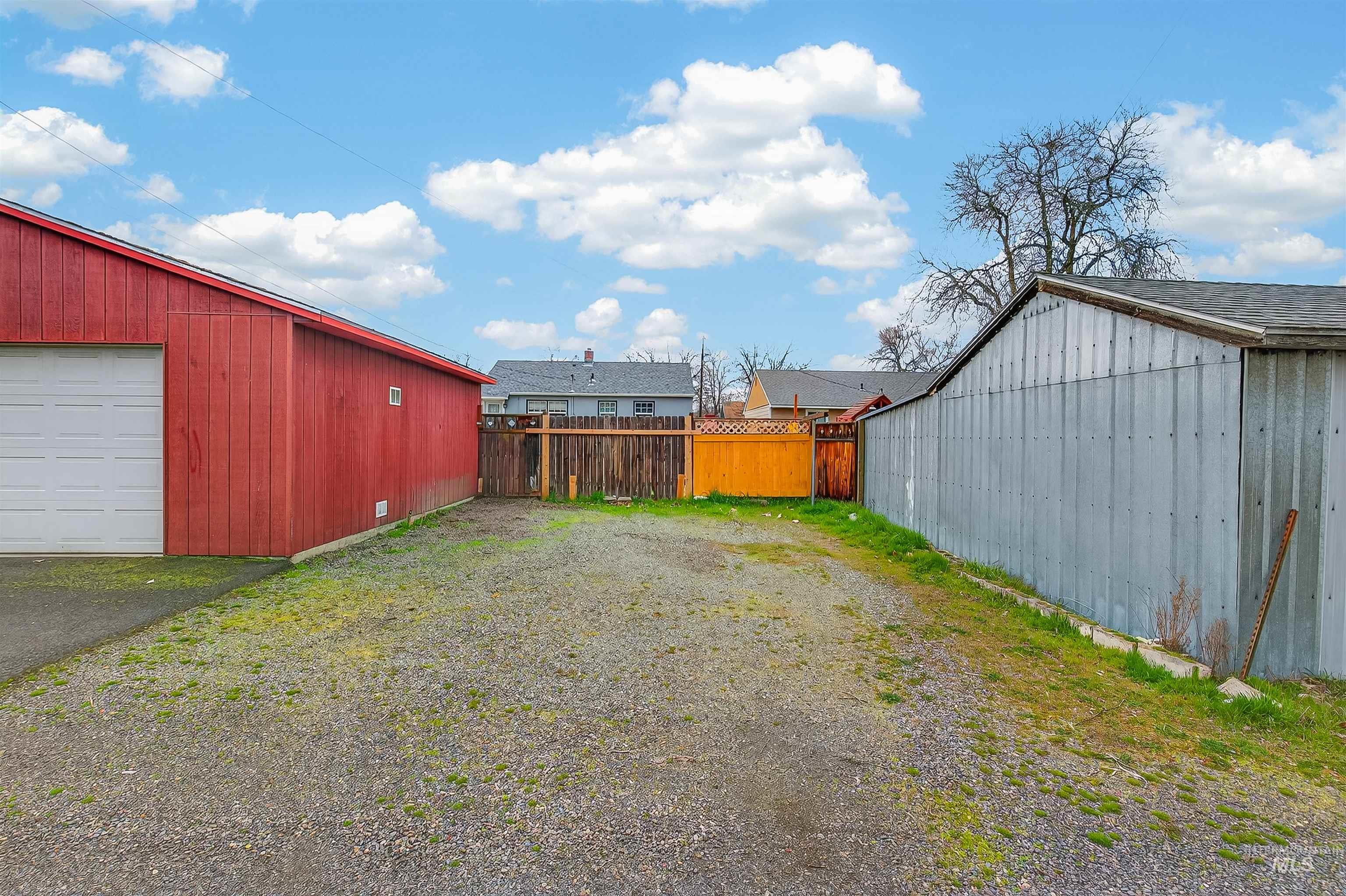 835 12th Street Clarkston, WA 99403 - Photo 36 of 39 View of yard with an outdoor structure, a detached garage, driveway, and a pole building
