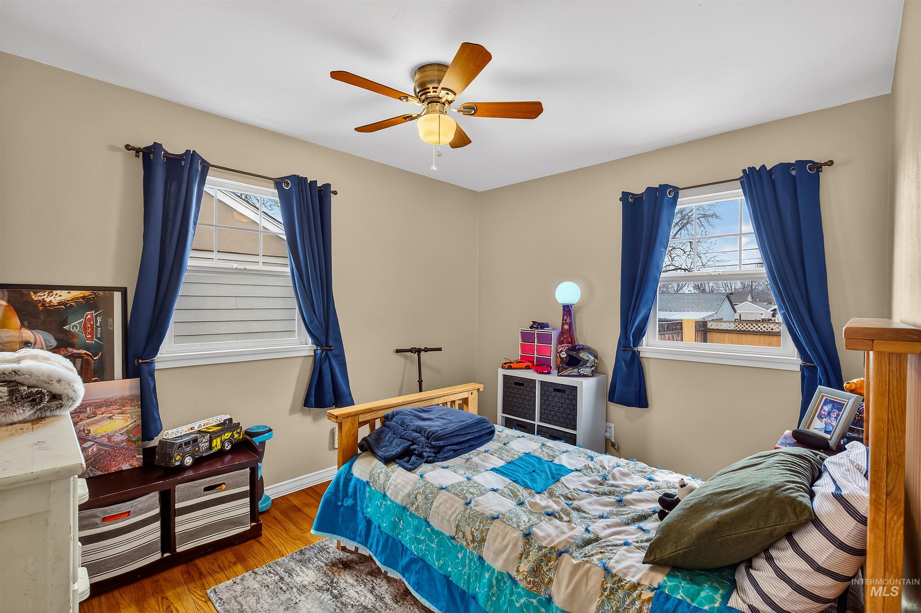 835 12th Street Clarkston, WA 99403 - Photo 10 of 39 Bedroom with wood finished floors, a ceiling fan, and multiple windows