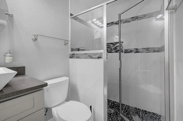 a white toilet sitting next to a bathroom sink