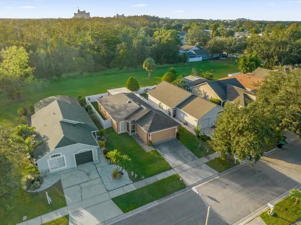 an aerial view of a house with big yard