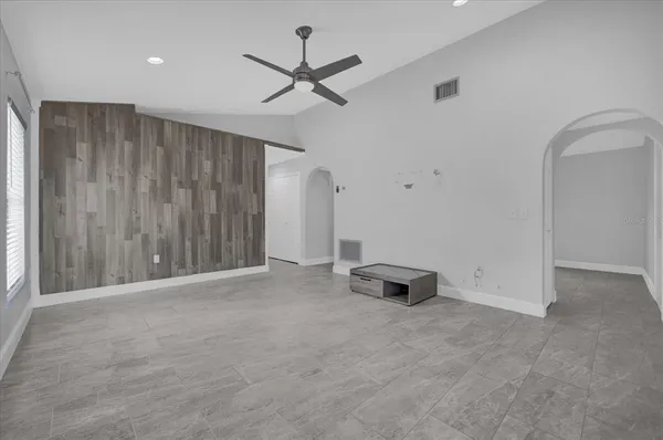 an empty room with closet and windows