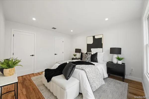 a bedroom with a bed and a potted plant
