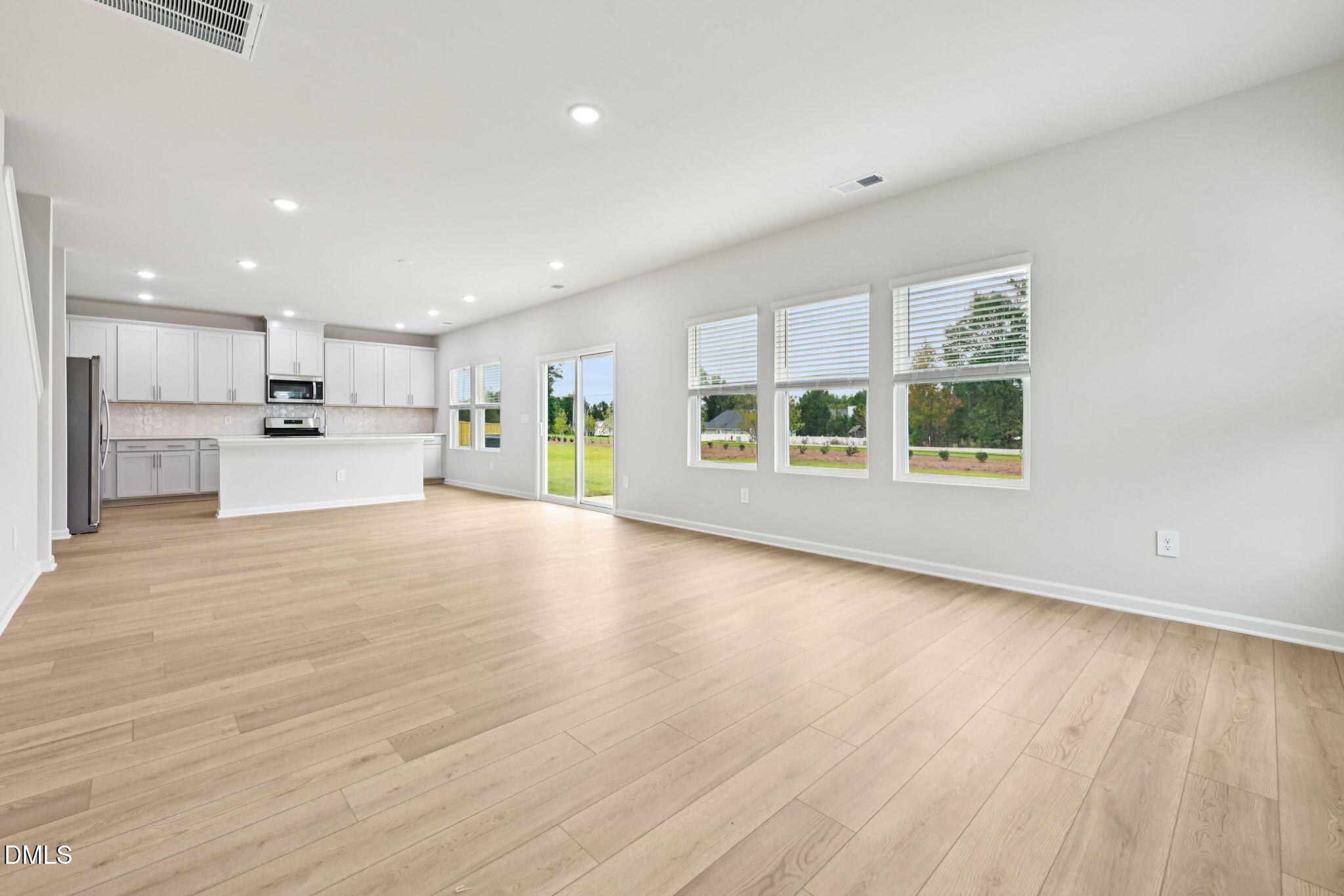 85 Thistle Patch Place Angier, NC 27501 - Photo 11 of 40 a view of an empty room with a window and wooden floor