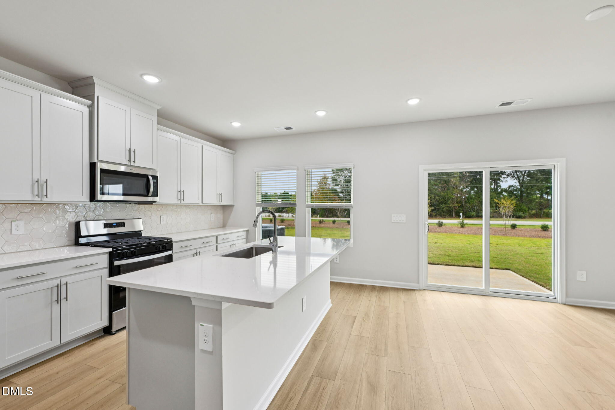 85 Thistle Patch Place Angier, NC 27501 - Photo 12 of 40 a kitchen with counter top space a sink and cabinets