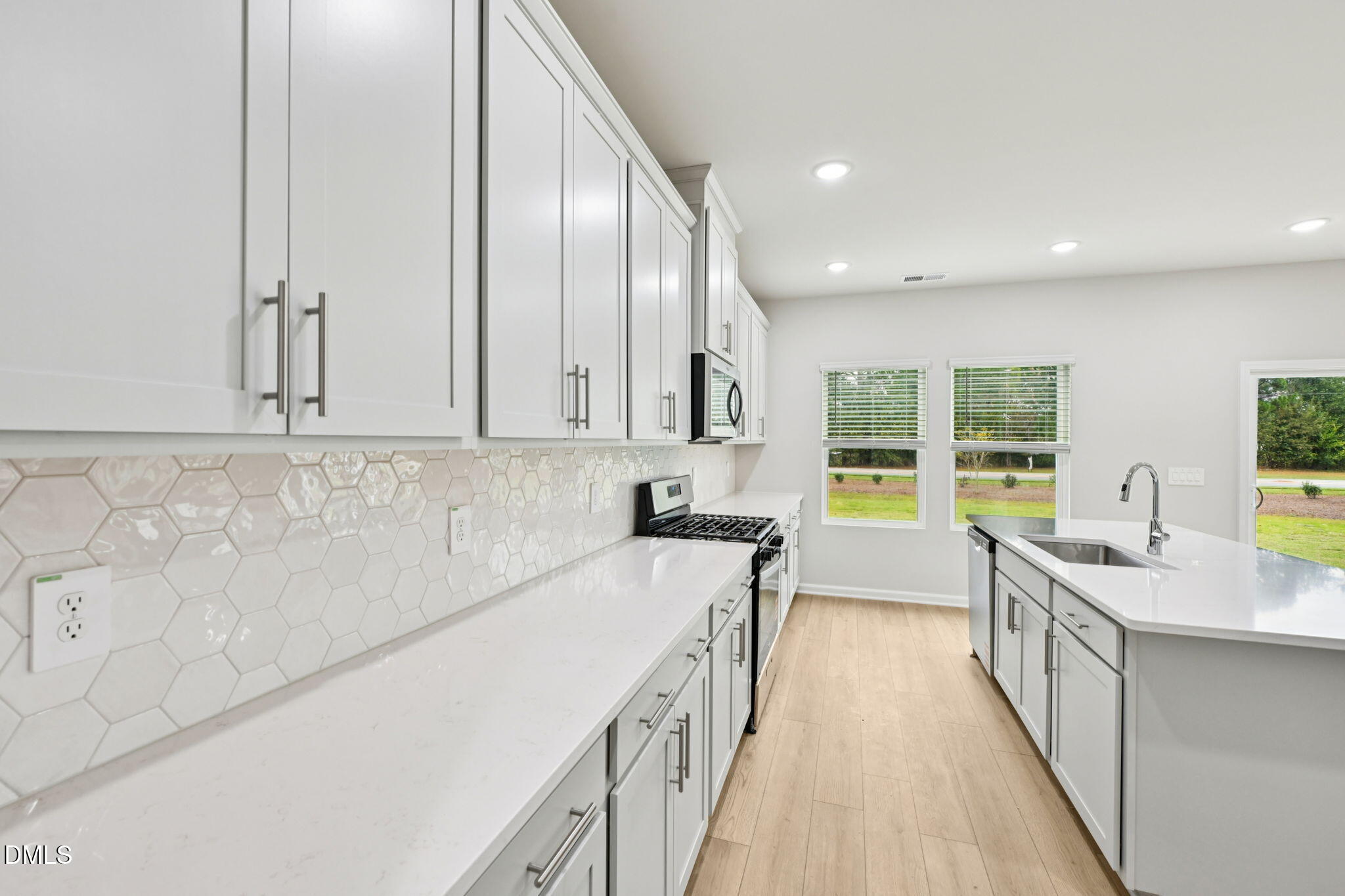 85 Thistle Patch Place Angier, NC 27501 - Photo 15 of 40 a view of a kitchen with a sink and windows