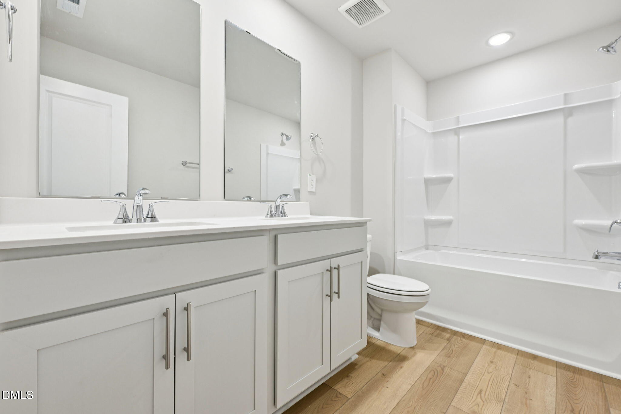 85 Thistle Patch Place Angier, NC 27501 - Photo 21 of 40 a bathroom with a double vanity sink a toilet a shower and a mirror