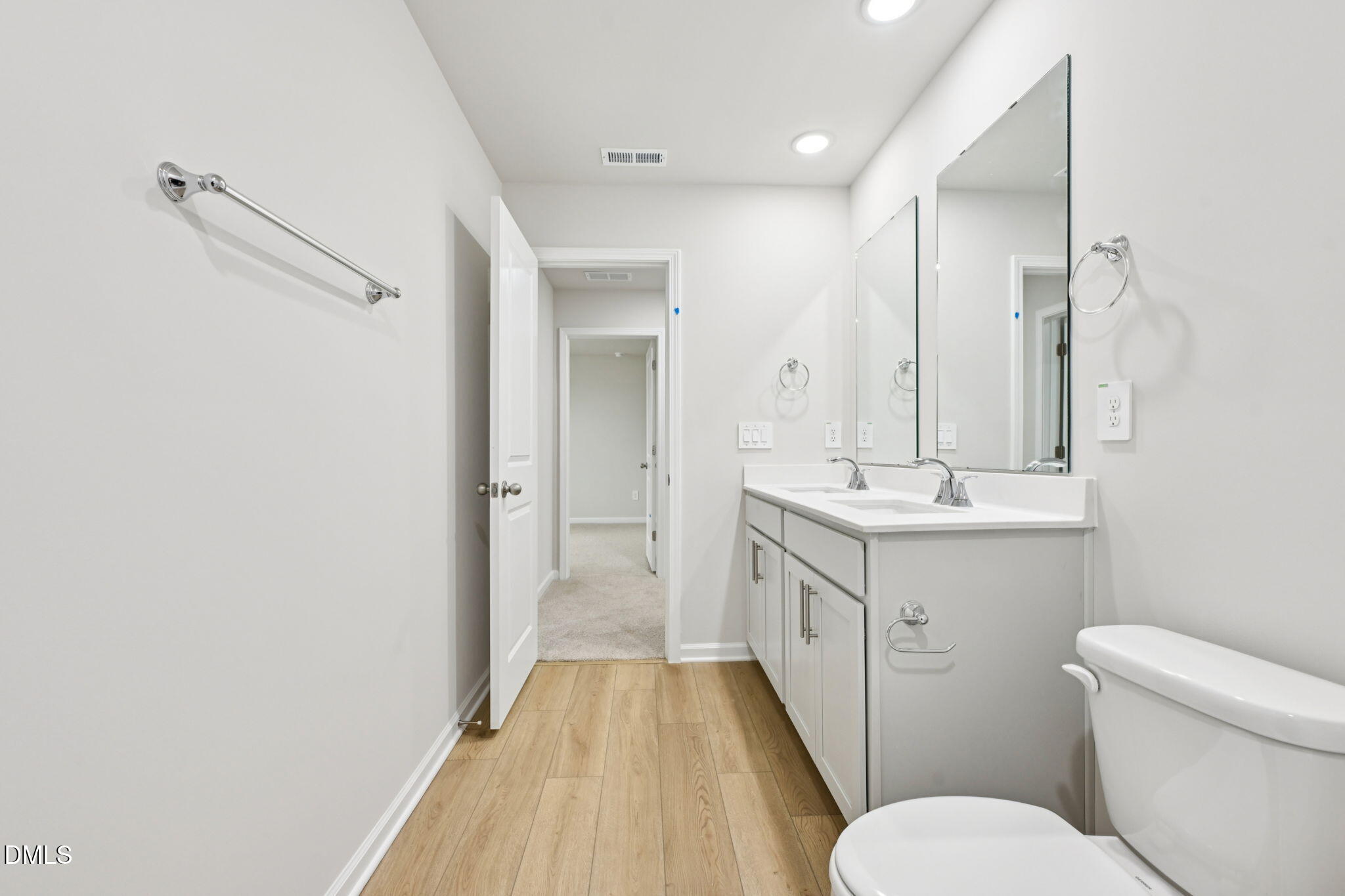 85 Thistle Patch Place Angier, NC 27501 - Photo 22 of 40 a bathroom with a sink a toilet a mirror and vanity