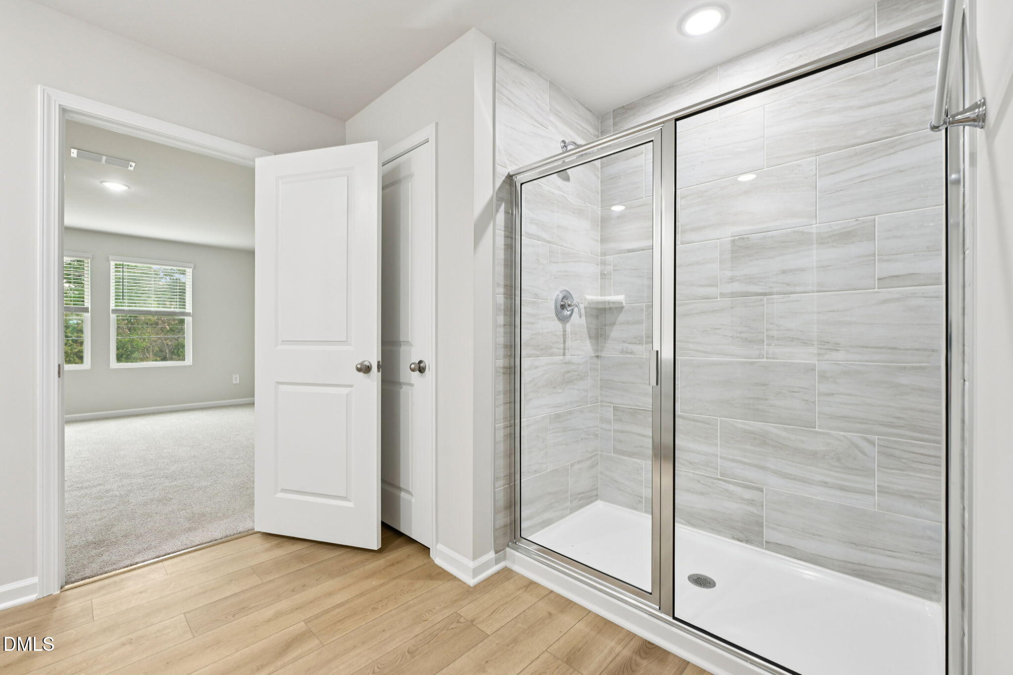 85 Thistle Patch Place Angier, NC 27501 - Photo 31 of 40 a bathroom with a glass shower door