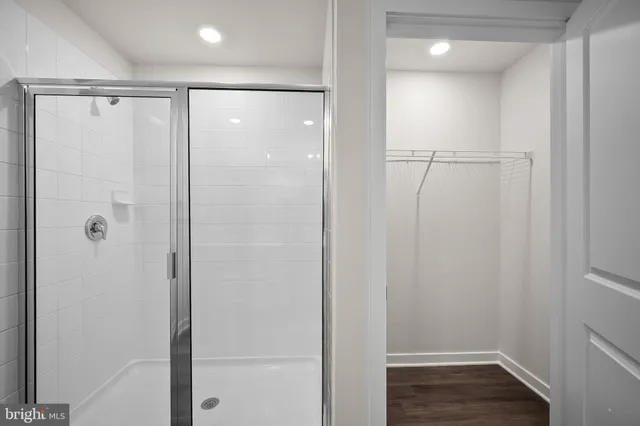 a view of a hallway with wooden shelves