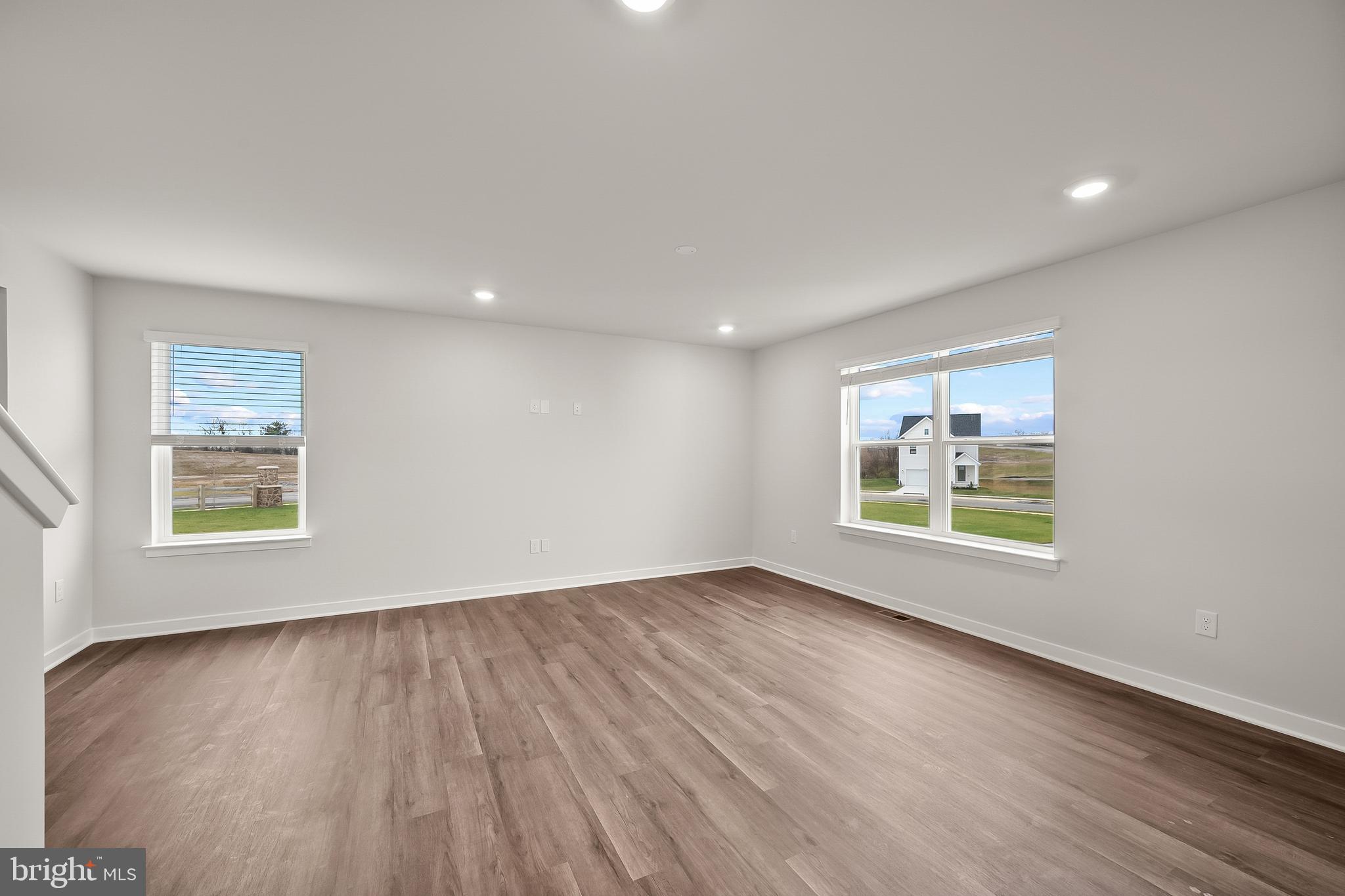 258 Eclipse Street Ranson, WV 25438 - Photo 7 of 46 a view of an empty room with a window and wooden floor