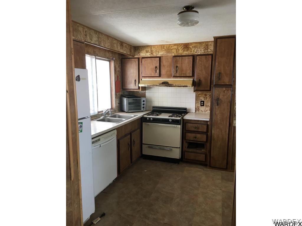 1797 Rio Grande Road Bullhead City, AZ 86442 - Photo 4 of 6 a kitchen with a refrigerator stove and sink