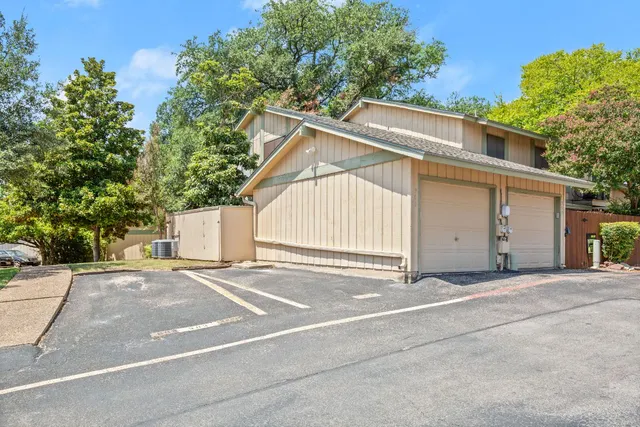a view of a house with a yard and garage