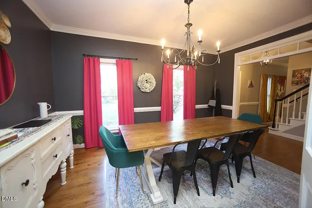 a view of a livingroom with wooden floor and a sink