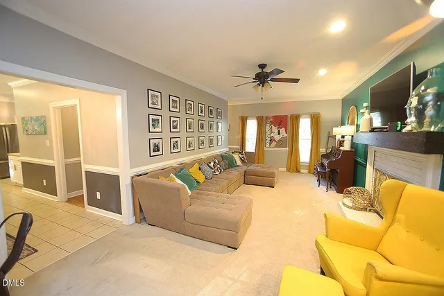 a living room with furniture a fireplace and a flat screen tv