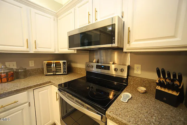 a kitchen with a sink dishwasher stove and refrigerator