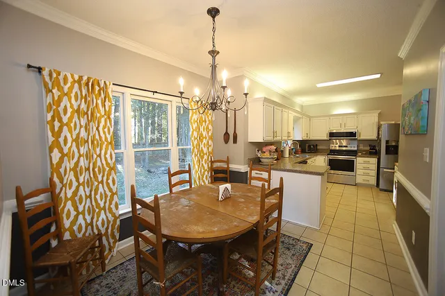 a large white kitchen with stainless steel appliances a stove a sink and cabinets